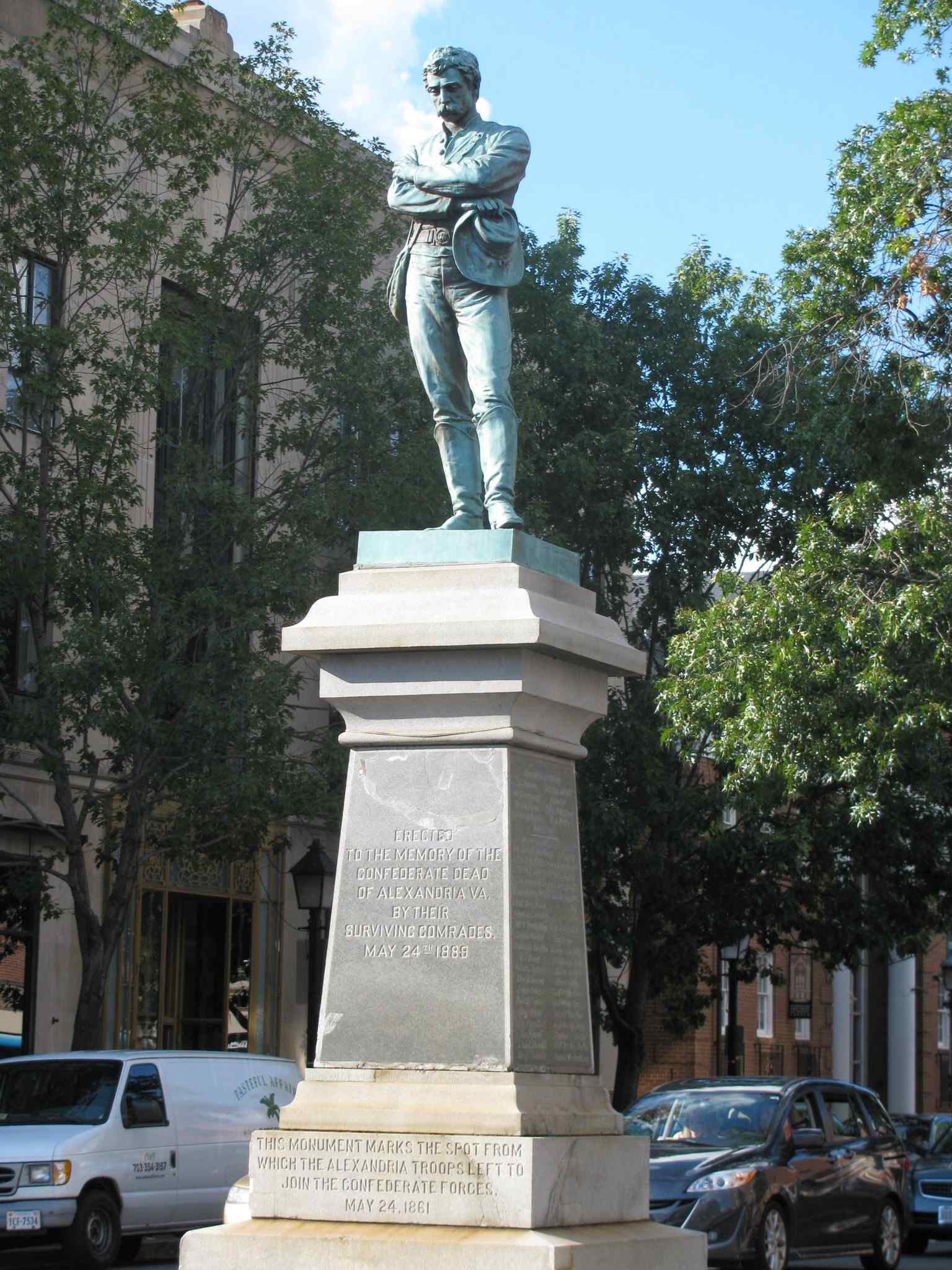 This vertical shot provides a closer look at the Appomattox statue, highlighting the lone Confederate soldier's crossed arms and downward gaze, reflecting the somber expression described.