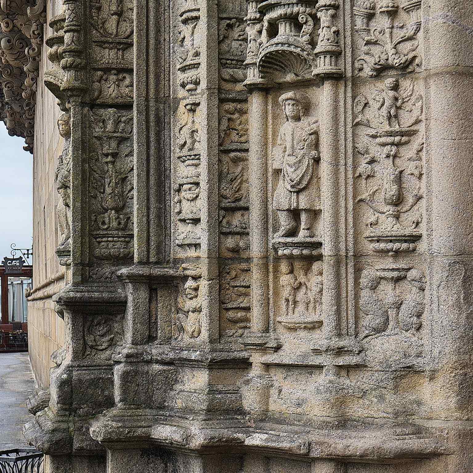 This detail on the Plateresque façade, carved in 1519 by Martín de Blas and Guillén Colás, represents a doctor, acknowledging the hospital's original role of providing medical care to pilgrims.