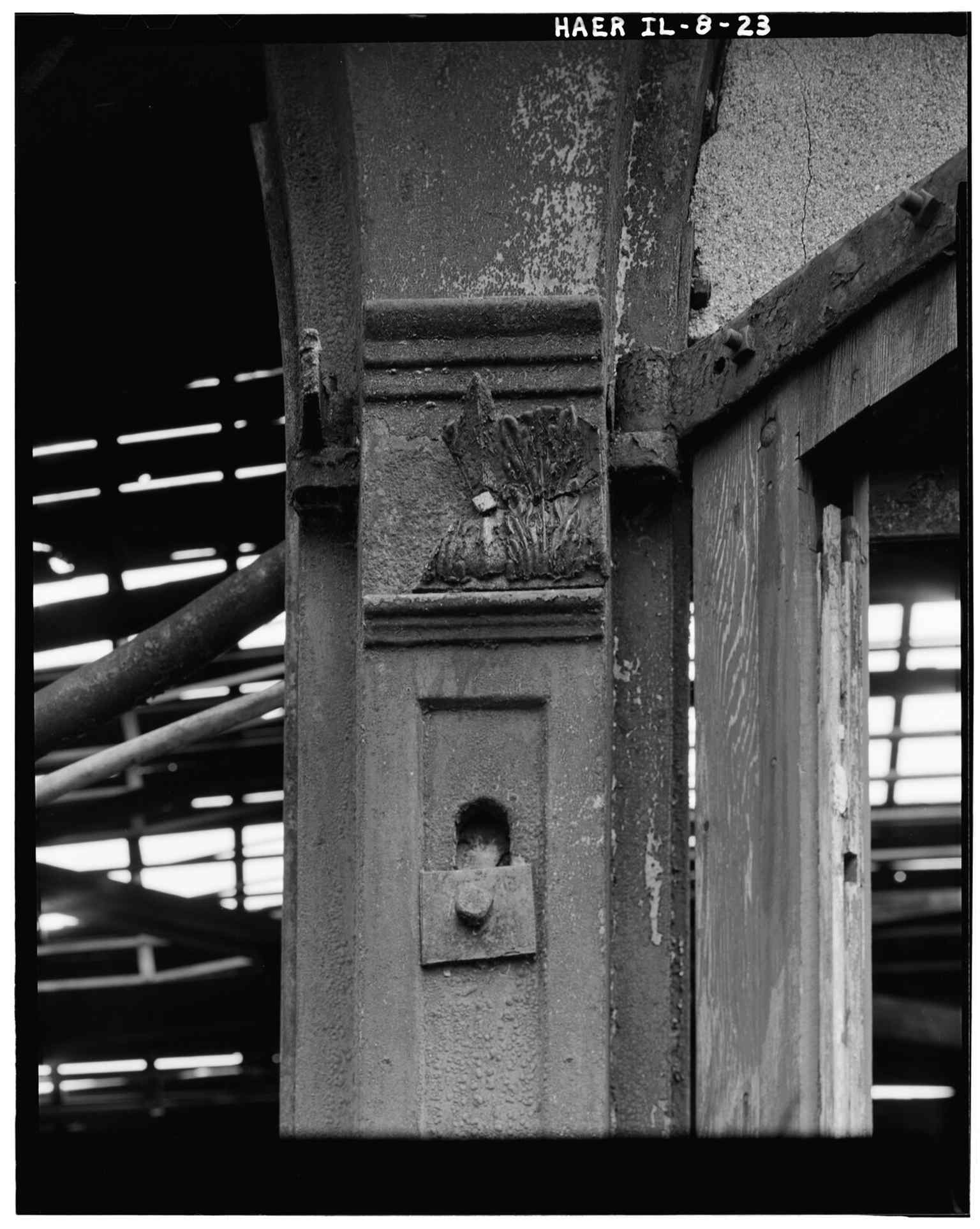 Decorative casting on the doorway into the roundhouse, one of the surviving architectural touches from the 19th-century railroad shop.