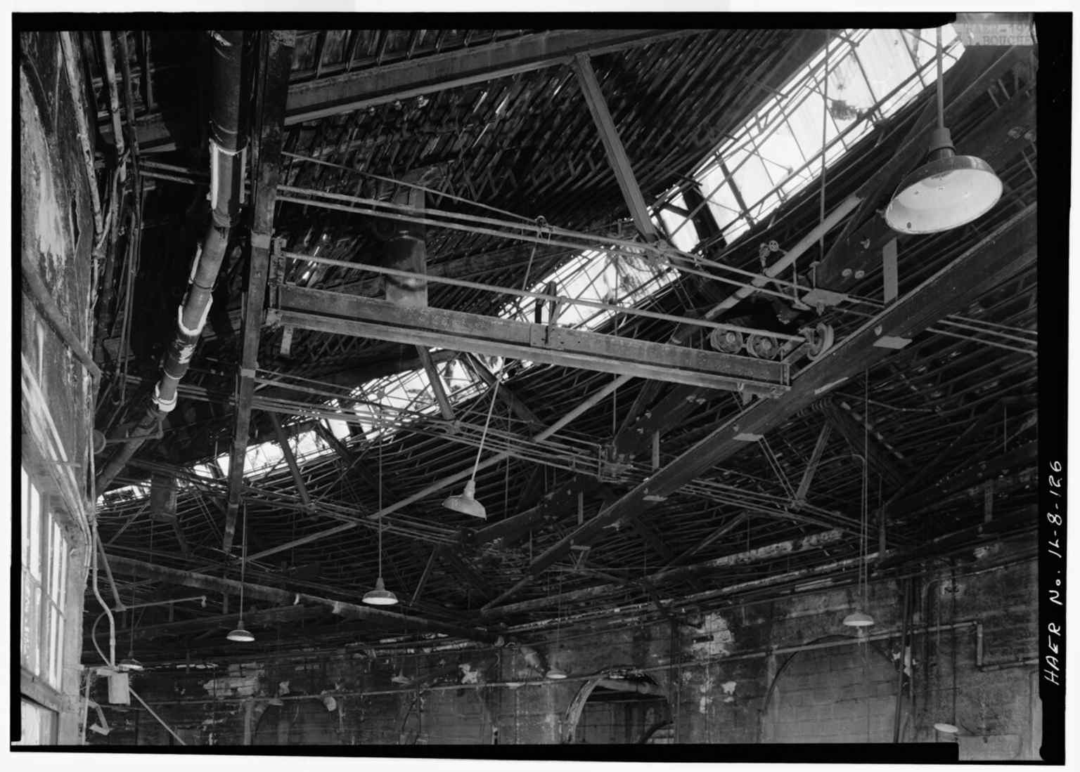 A close look at the shop roof truss system, illustrating the heavy industrial engineering behind the railroad repair buildings.