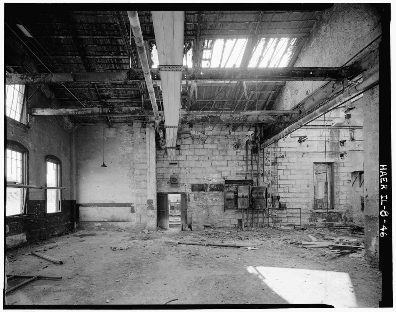 Inside the boiler room with its adjoining machine-shop wall, showing the utilitarian spaces that supported locomotive maintenance.