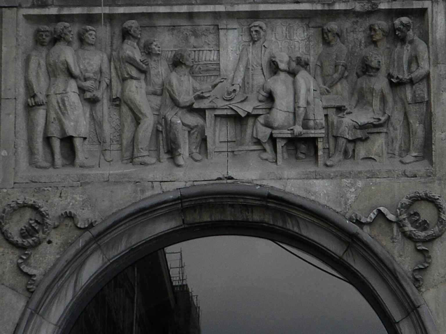 A façade relief on Constitution Square, one of the propaganda-era decorative details built into the architecture.
