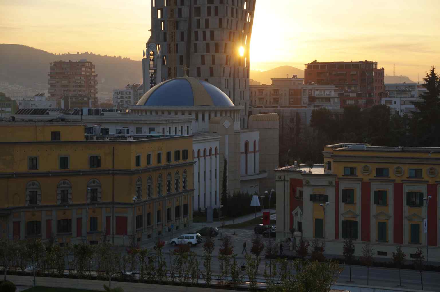 The Resurrection Cathedral stands prominently against the Tirana skyline at sunset, with its dome reaching 32.2 meters and bell tower 46 meters high.