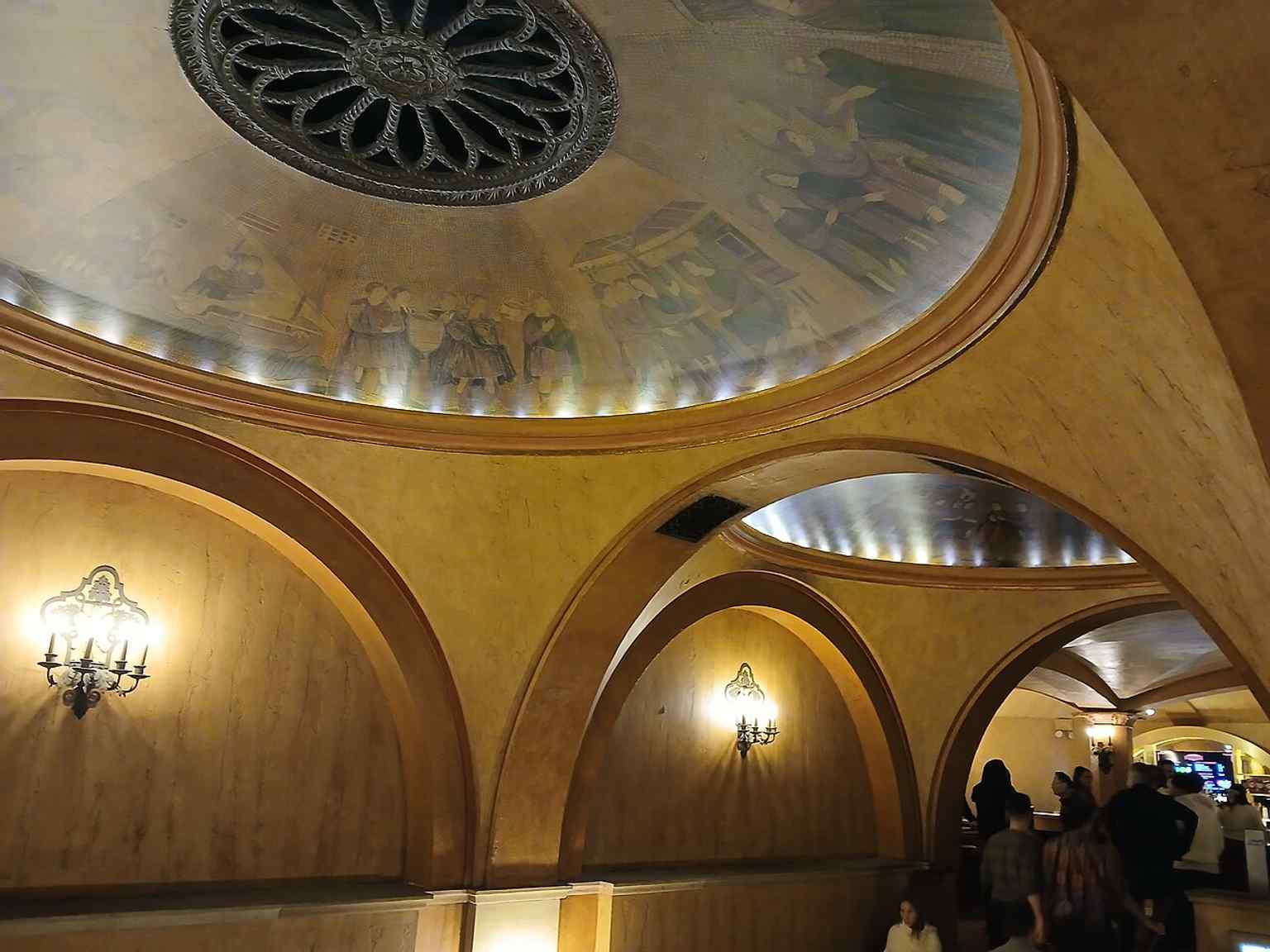 The proscenium arch is highlighted by half-columns with unique geometric designs and four concentric arches, a key element of the Byzantine-style interior.