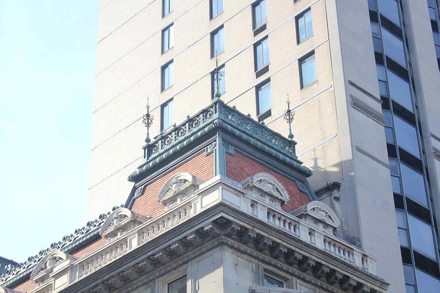 The mansion stands prominently among its modern neighbors, showcasing its enduring presence as a New York City designated landmark despite surrounding development.