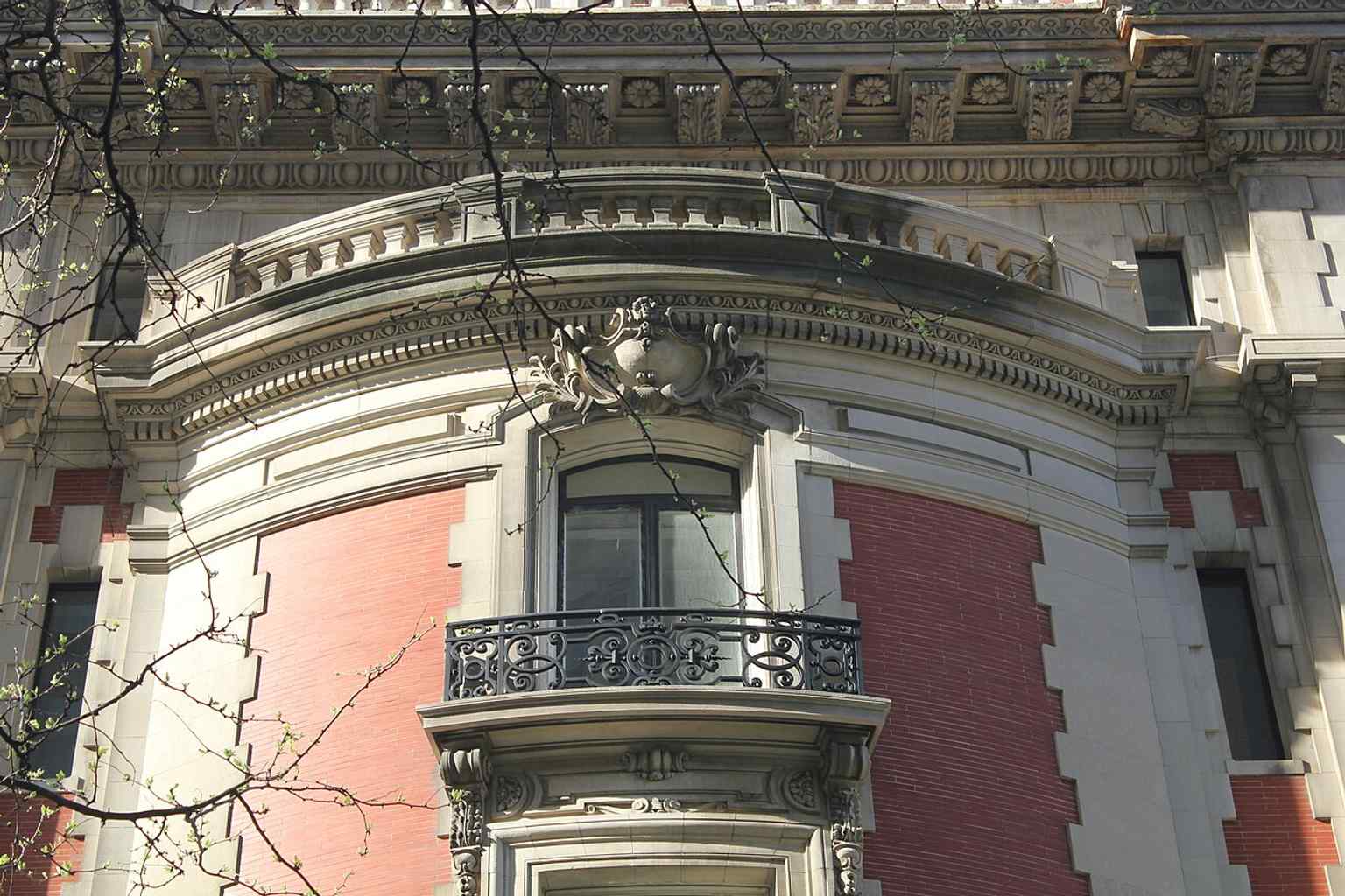 These second-story balconies, supported by brackets and topped by triangular pediments, add a distinct classical flair to the 82nd Street elevation.