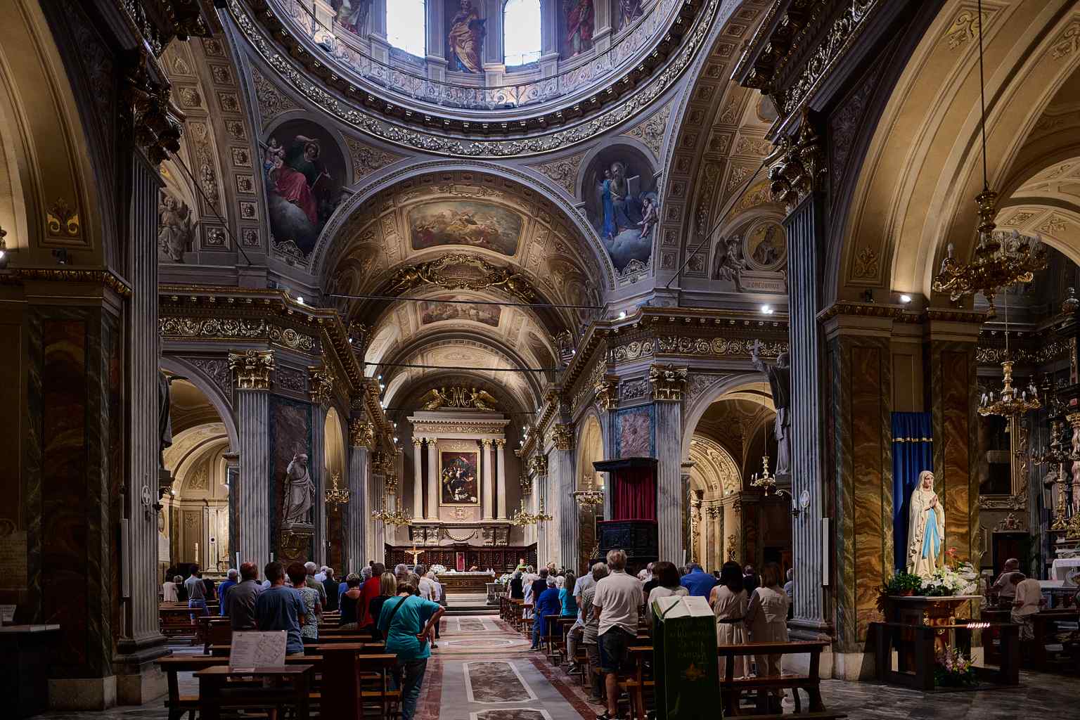 Step inside the Latin cross interior, where the dome, frescoed by Giuseppe Toselli, rises above the space rebuilt by Giovenale Boetto after the devastating 1656 collapse.