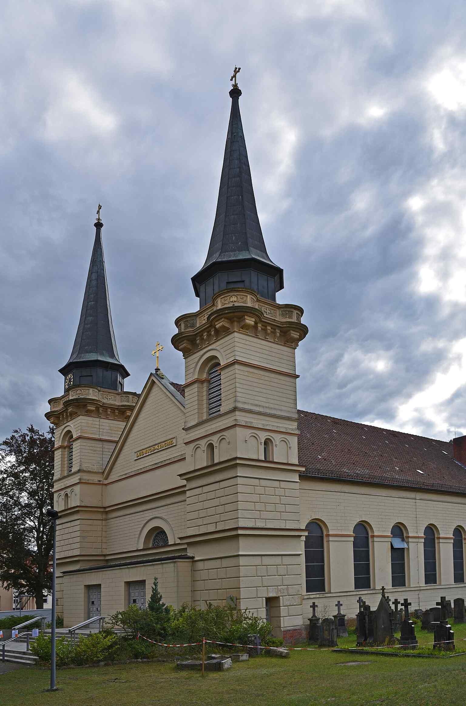 This exterior view of St. Ludwig showcases its pure Neoclassical design by Anton Spetzler, with the towers, added in 1881 by Conrad Wilhelm Hase, exhibiting elements of Romantic Historicism.