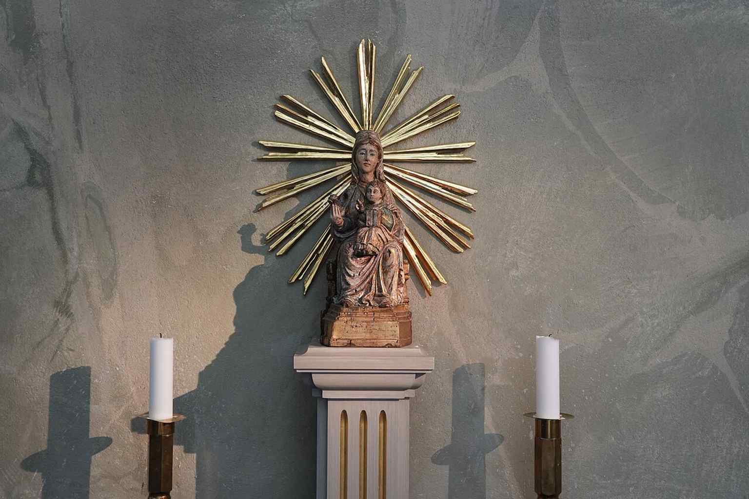 A side-chapel Marian figure, one of the smaller devotional details that give the church its layered interior character.