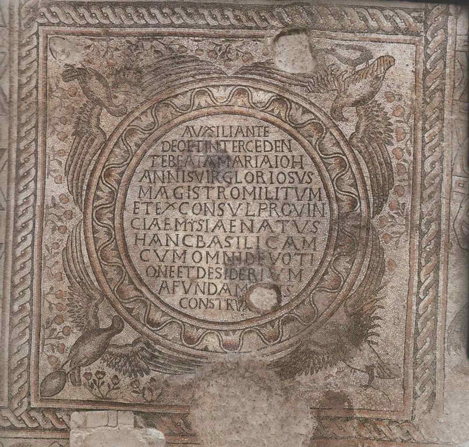 A mosaic inscription panel from the floor, part of the remarkable pavement program that includes unusually narrative scenes.