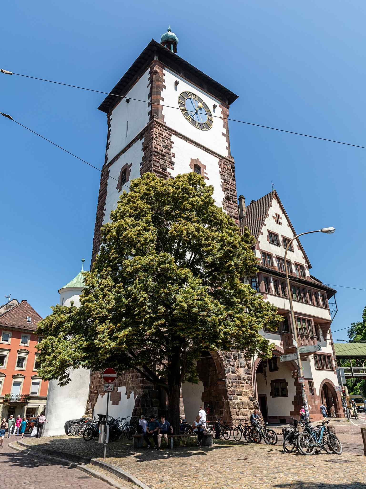 A close exterior detail of the Schwabentor façade — ideal for showing the building’s restored medieval stonework and the later decorative additions.
