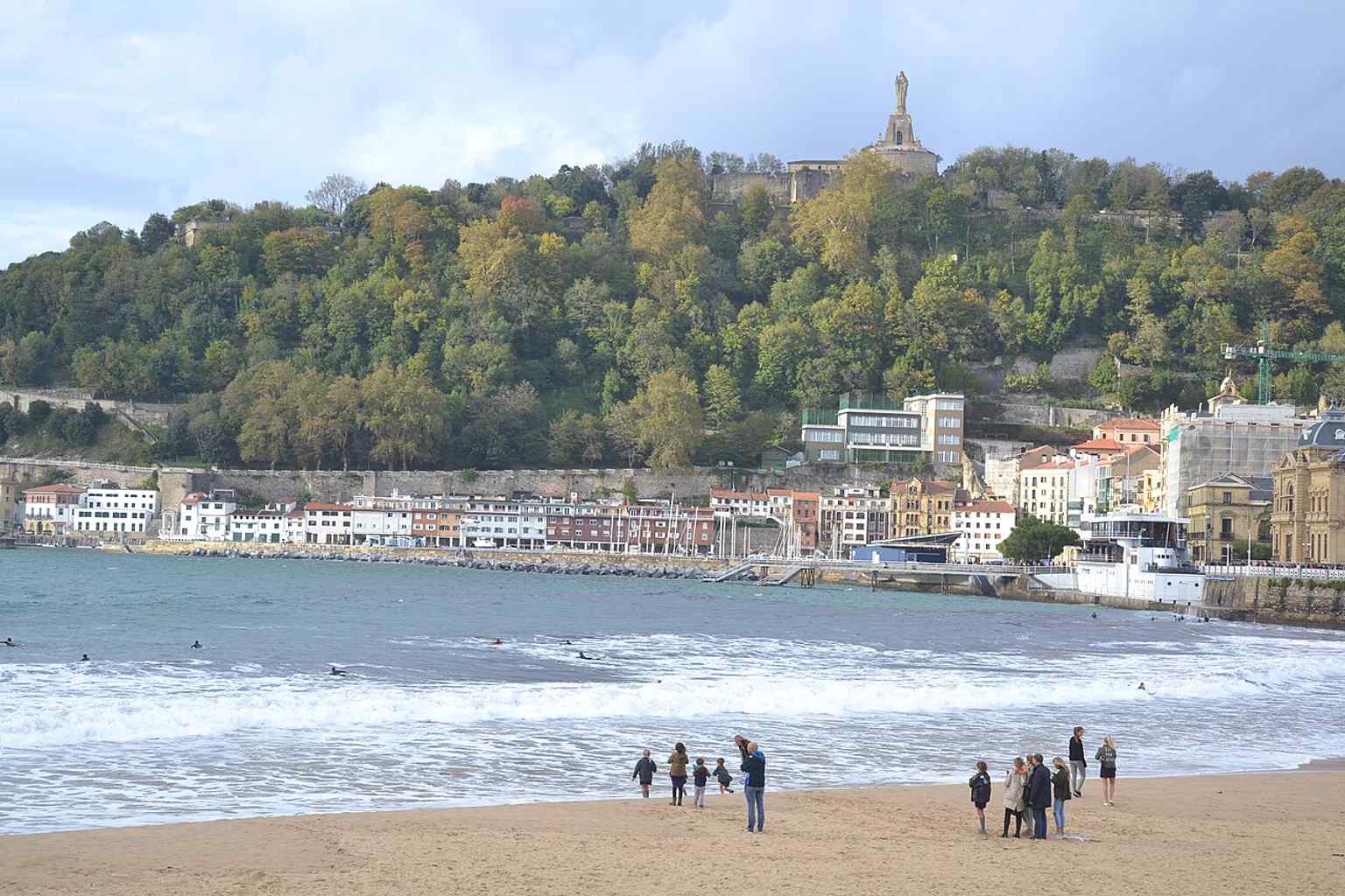 A broad daylight view of La Concha Beach in Donostia-San Sebastián, showing the long urban shoreline that has made it one of Europe’s most famous city beaches.