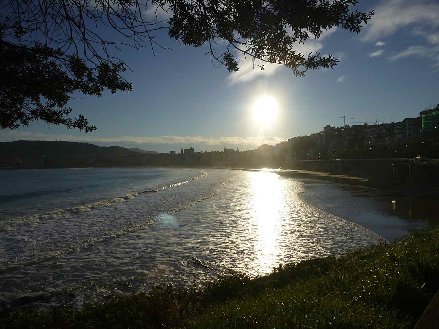 Evening light on La Concha’s shoreline, with the bay’s long curve emphasizing its distinctive shell-like shape.