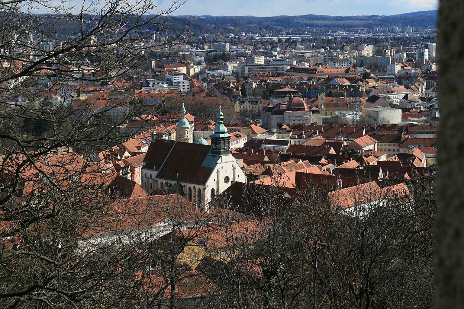 Seen from Schlossberg, the Cathedral and the twin-domed Mausoleum show how Ferdinand II’s tomb became part of Graz’s landmark silhouette.
