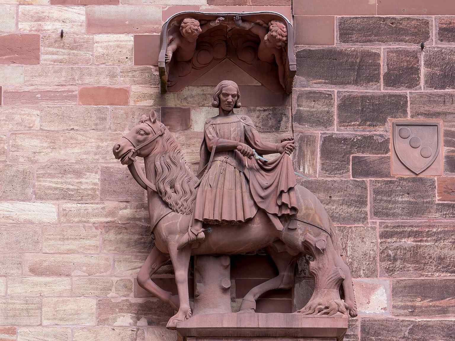 Saint Martin on the facade — one of the two tower saints named in the source, guarding the southern tower.