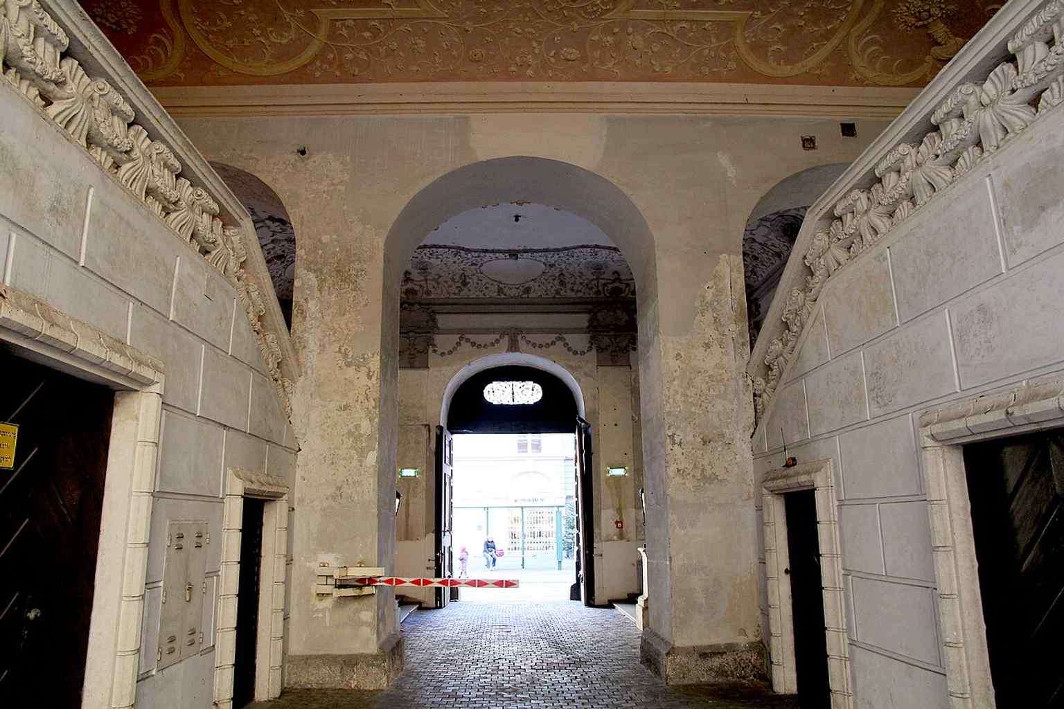 Ground-floor interior looking toward Sackstraße, illustrating the palace’s entrance sequence and the richly finished lower level.