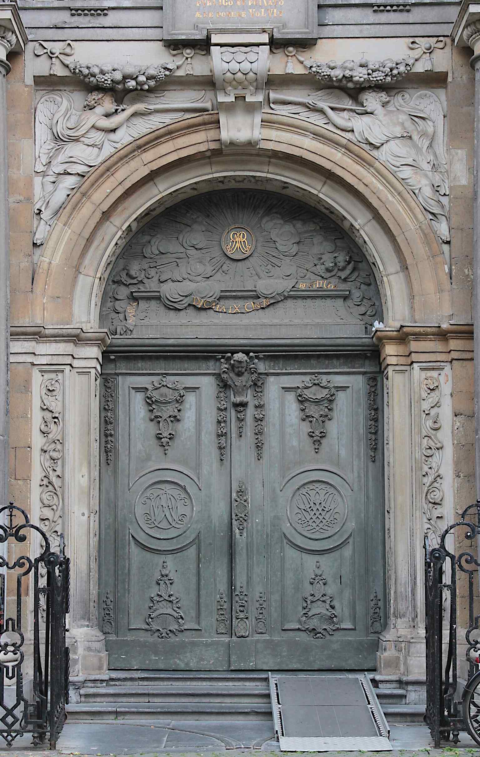 A close look at a church door, evoking the hidden layers of access that connect the building to the Antwerp Ruien below.