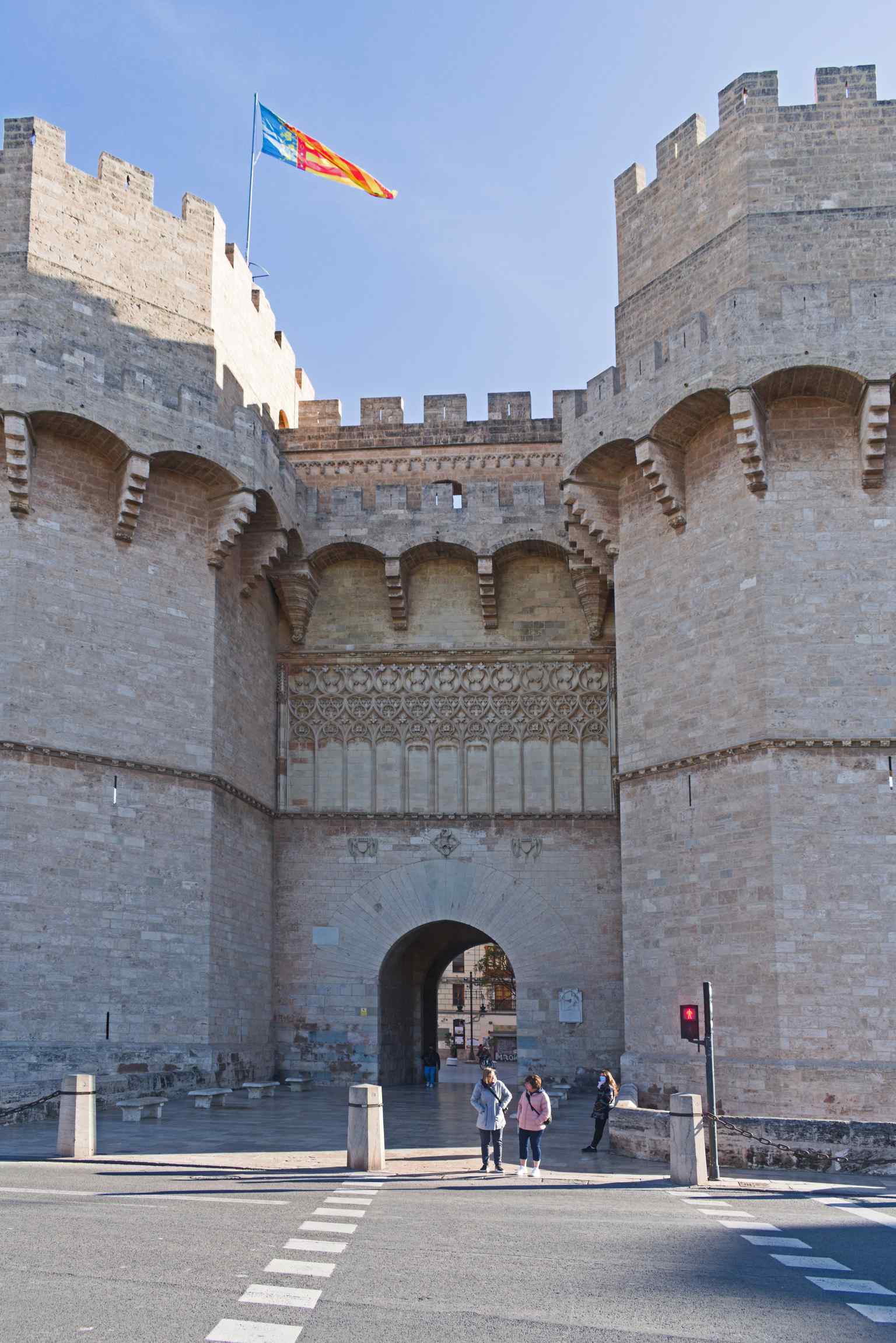 A close-up of the solid limestone blocks and the imposing polygonal shape of the towers (2022).