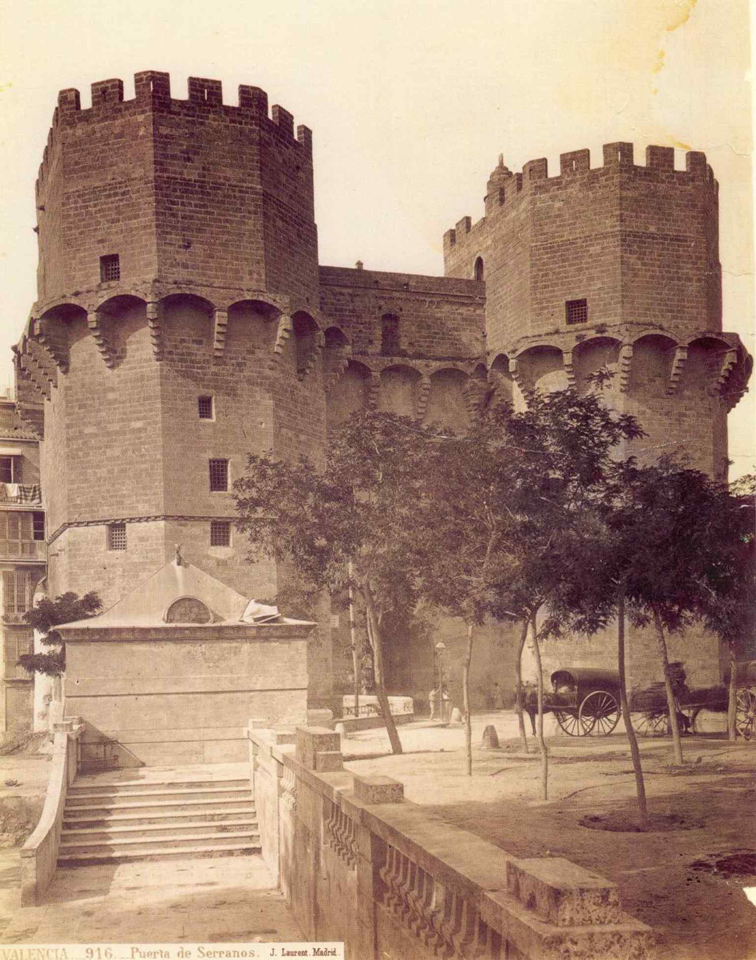An archival photo of the Torres de Serranos from 1870, showing the towers before modern urban expansion (1870).