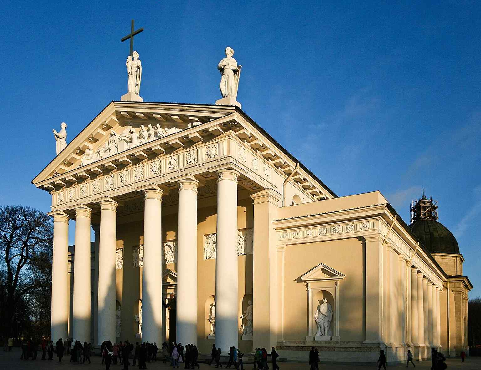 The west facade in winter light — this neoclassical front reflects Laurynas Gucevičius’s 18th-century rebuild after earlier fires and collapses.
