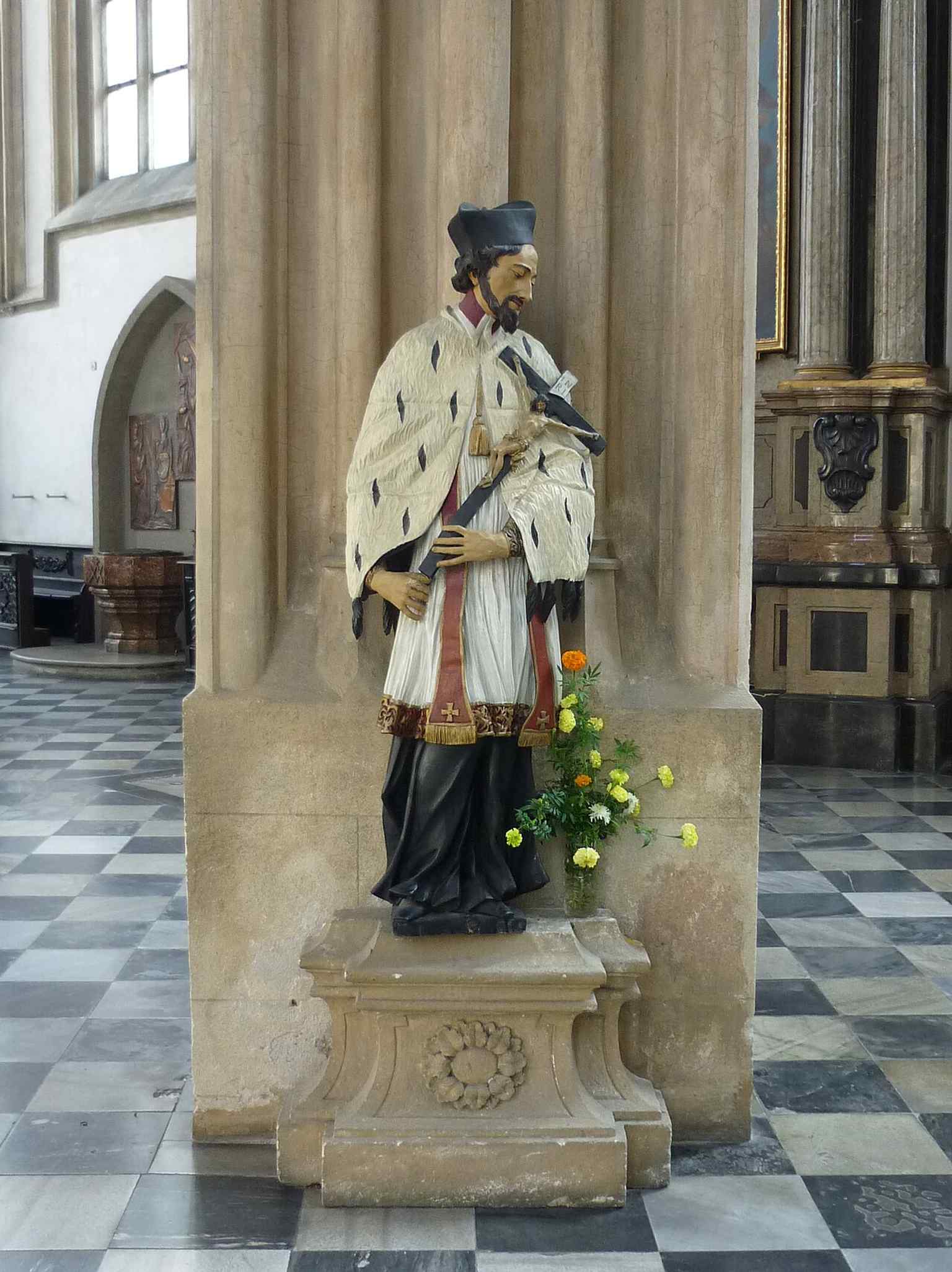 A statue of St. John of Nepomuk, one of the Baroque devotional figures that filled the church after its 18th-century makeover.