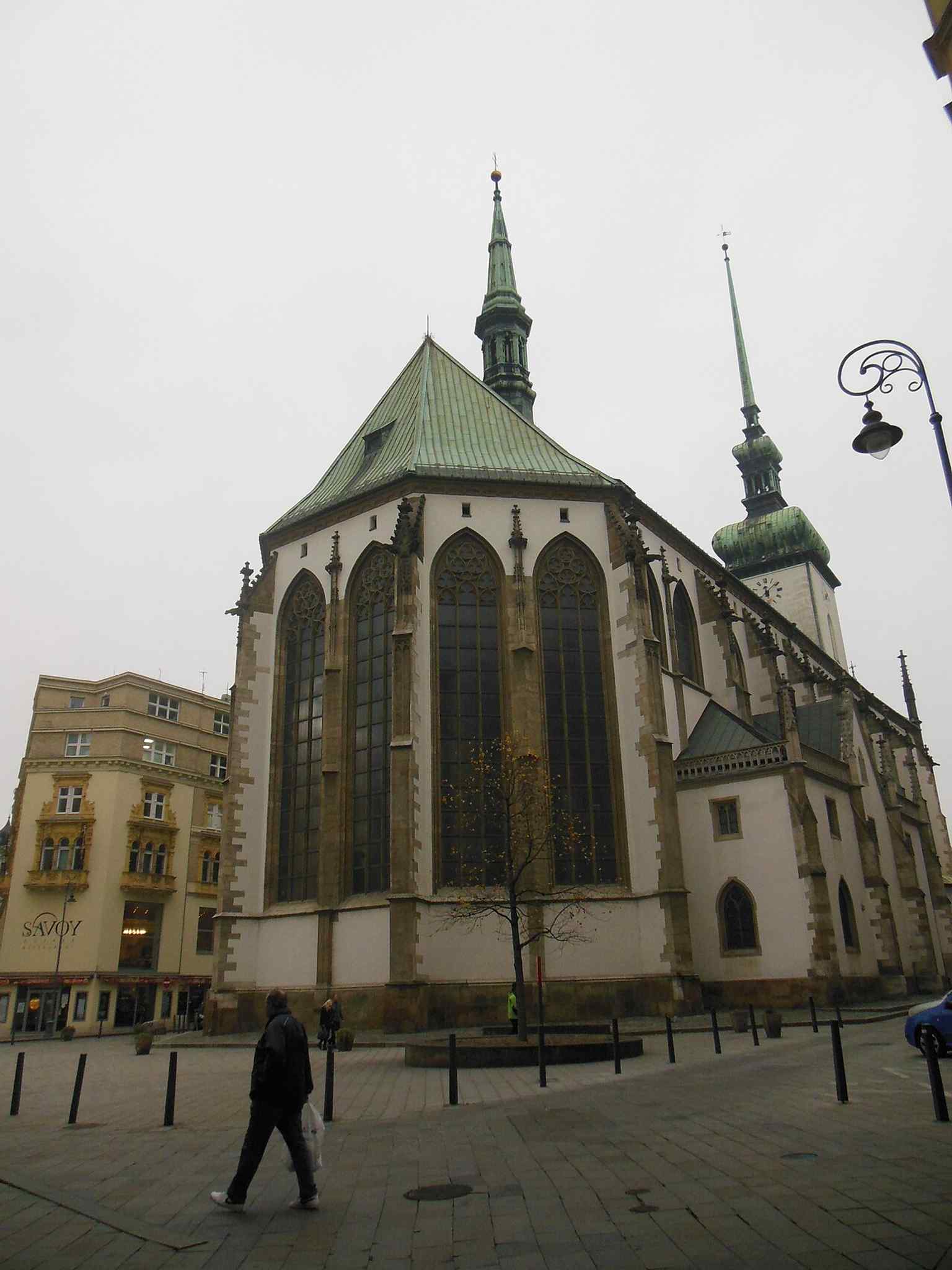 A side view from Běhounská street that helps show the church’s long Gothic body and attached side volumes.