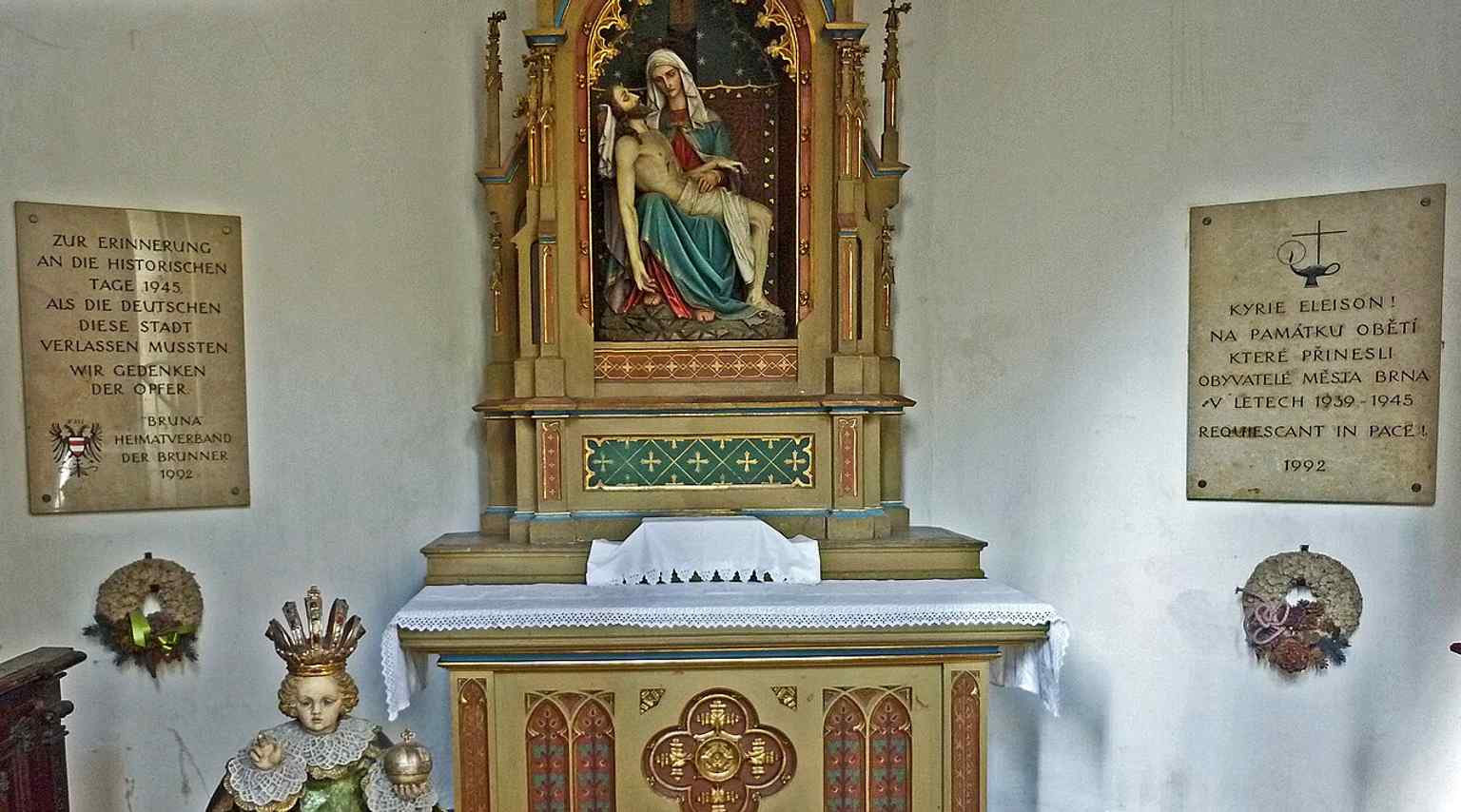 Memorial plaques in a side chapel, reflecting the church’s modern commemorative role alongside its medieval and Baroque heritage.