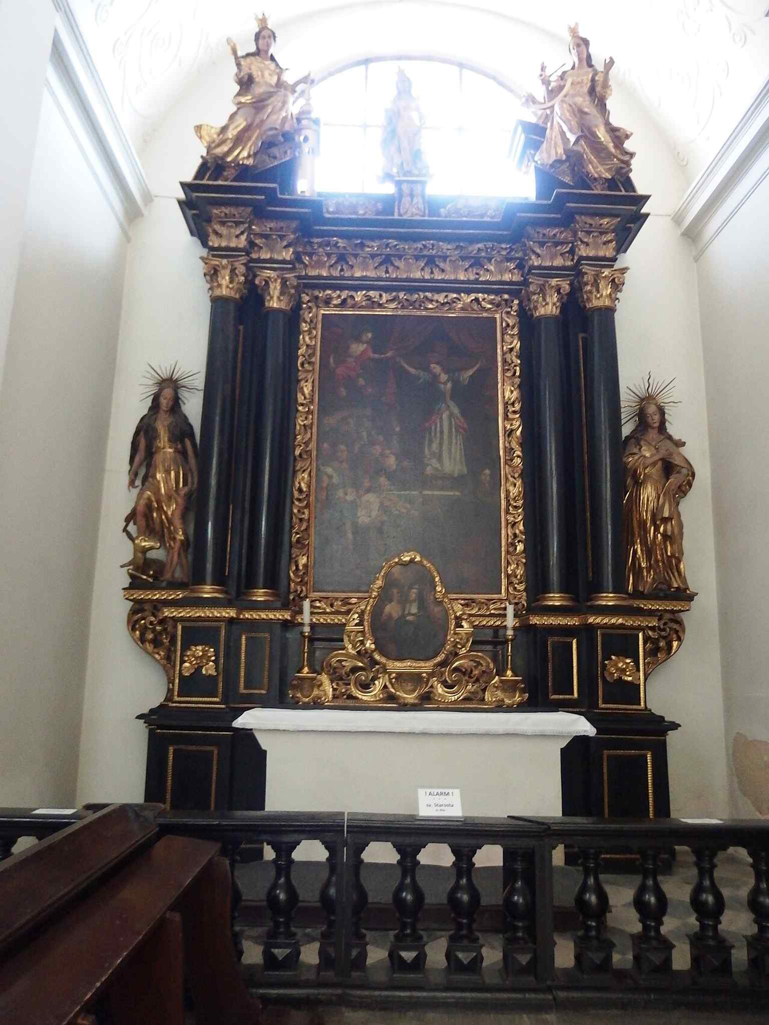 The altar of Saint Starosta, connected to the painted altarpieces described in the source.