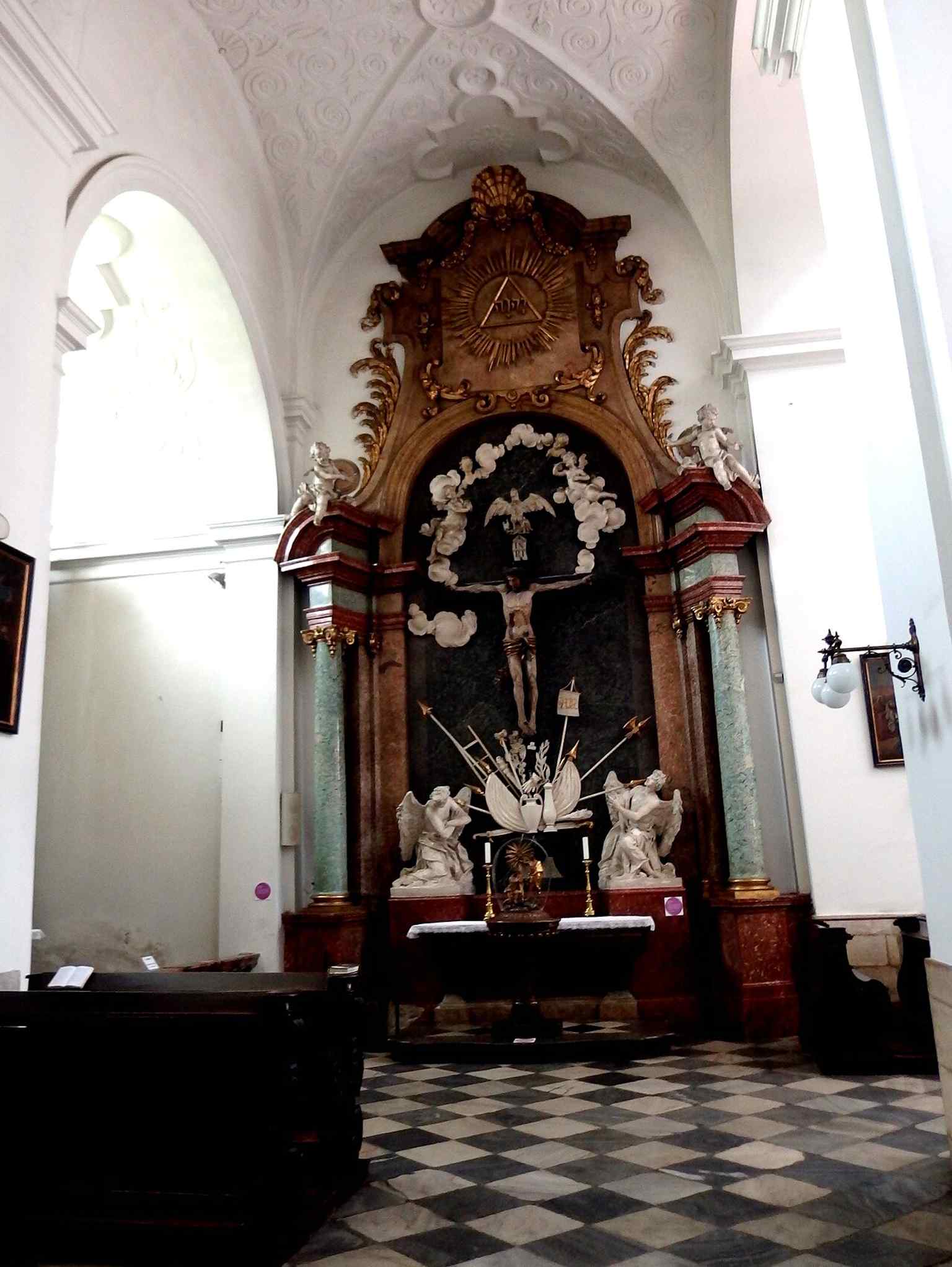 The Holy Cross altar, another strong example of the church’s black-and-gold Baroque side altars.