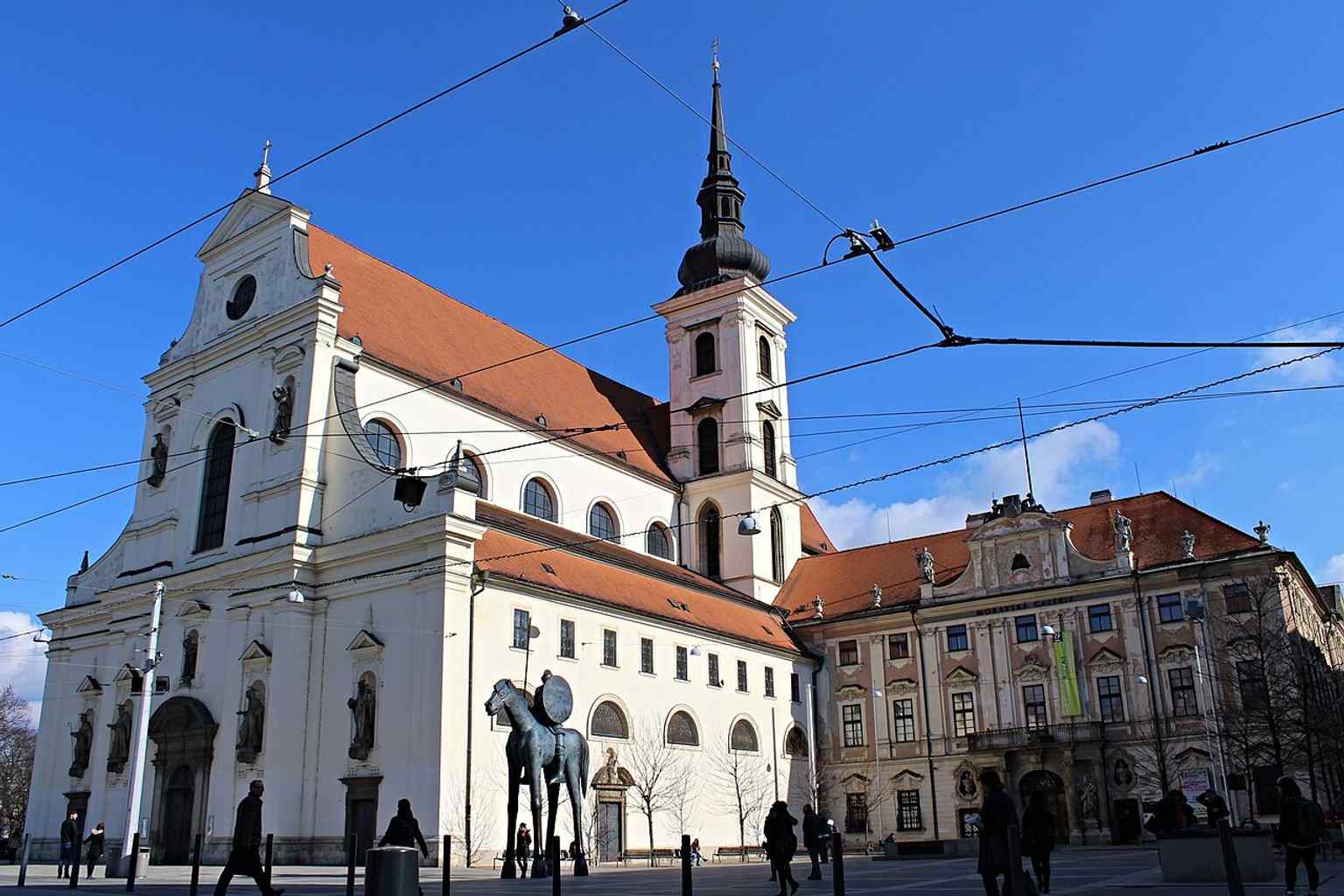 A wider composition with the Governor’s Palace nearby, showing the church in Brno’s monumental urban setting.