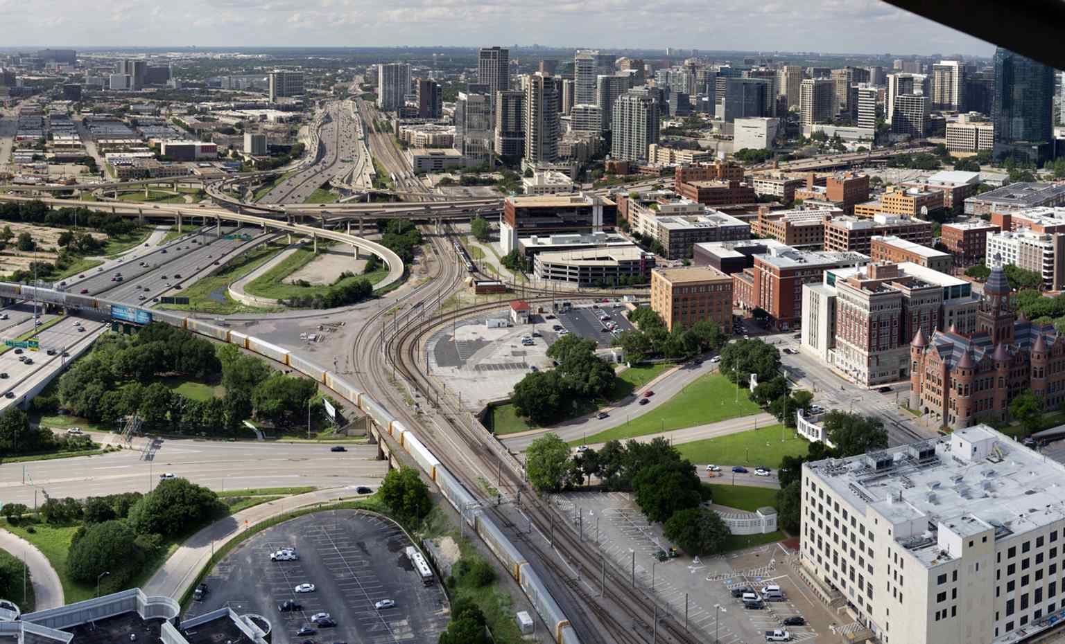 This overhead view places Dealey Plaza in the broader downtown landscape, revealing the plaza’s setting near the Trinity and the city skyline.