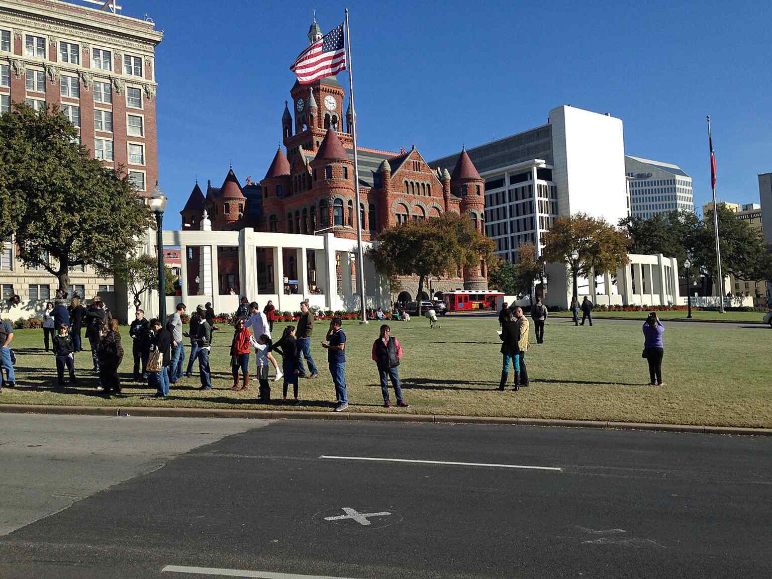 A pavement X marks the approximate spot where President Kennedy was fatally shot on Elm Street.