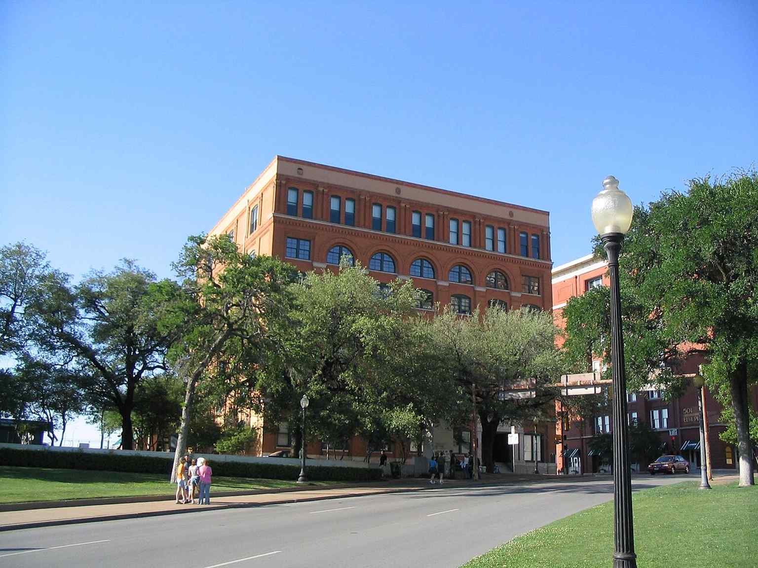 The Texas School Book Depository side of Dealey Plaza appears here with the historic district buildings that remained largely unchanged since 1963.