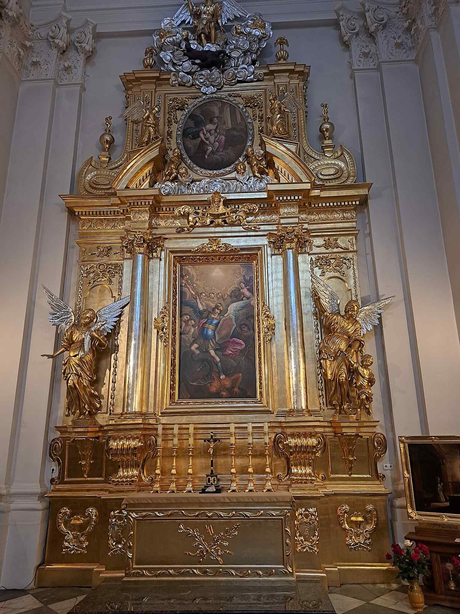 St. Michael the Archangel’s altar, showing the church’s Baroque side chapels and sculptural ornament.
