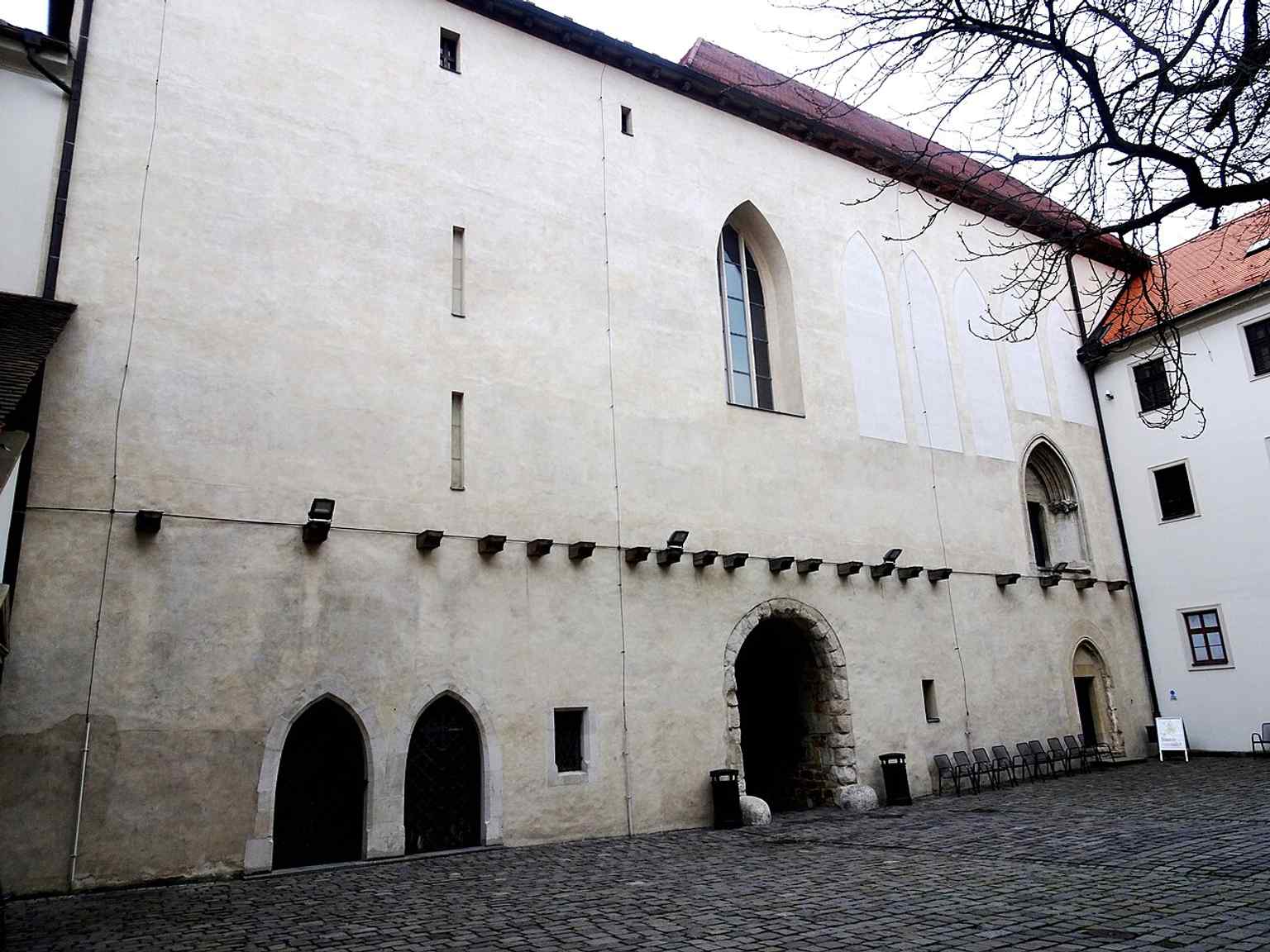 The first courtyard shows the layered architecture of Špilberk, where the medieval castle and later fortress still meet.