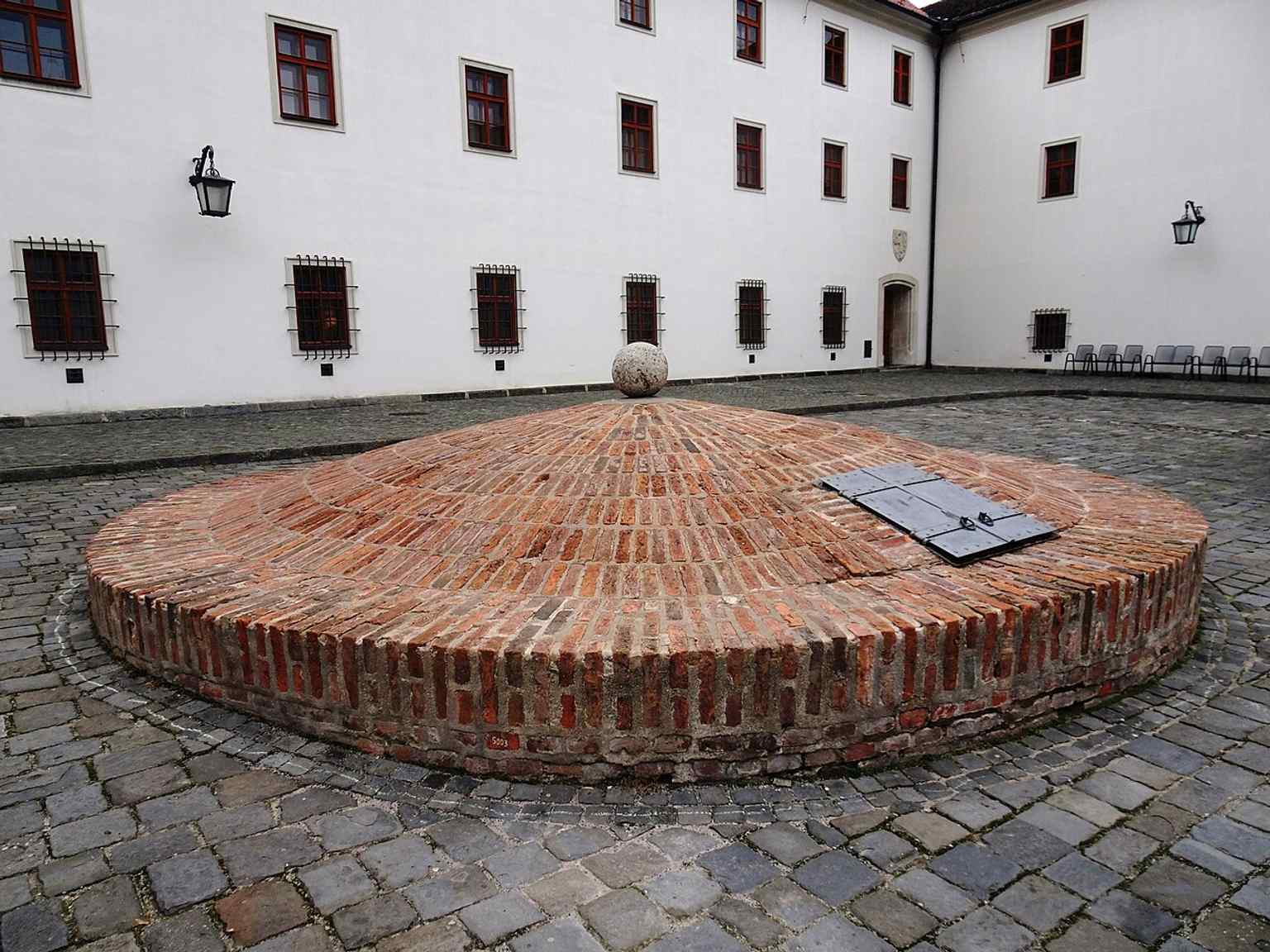 The cistern in the second courtyard is a reminder of the practical infrastructure that supported the fortress and later prison.