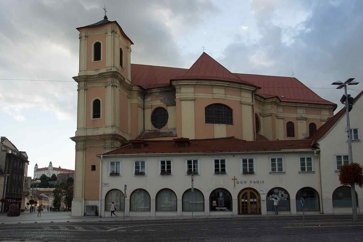 A clear full-front view of the Baroque church on Župné námestie, showing its rare concave façade and twin towers.