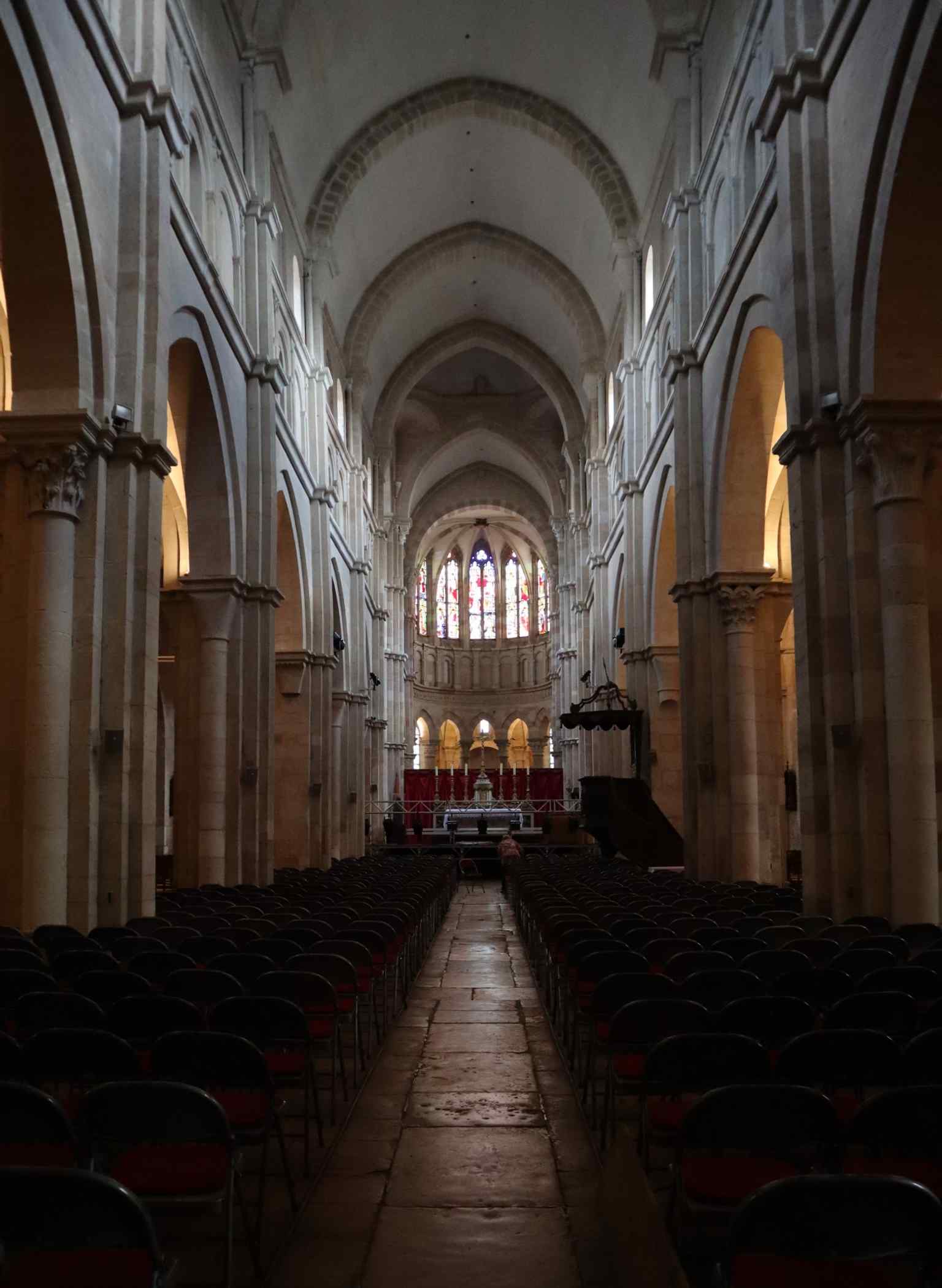 The nave, featuring impressive broken barrel vaults, represents the robust Romanesque architecture of the basilica's initial construction in the mid-12th century.
