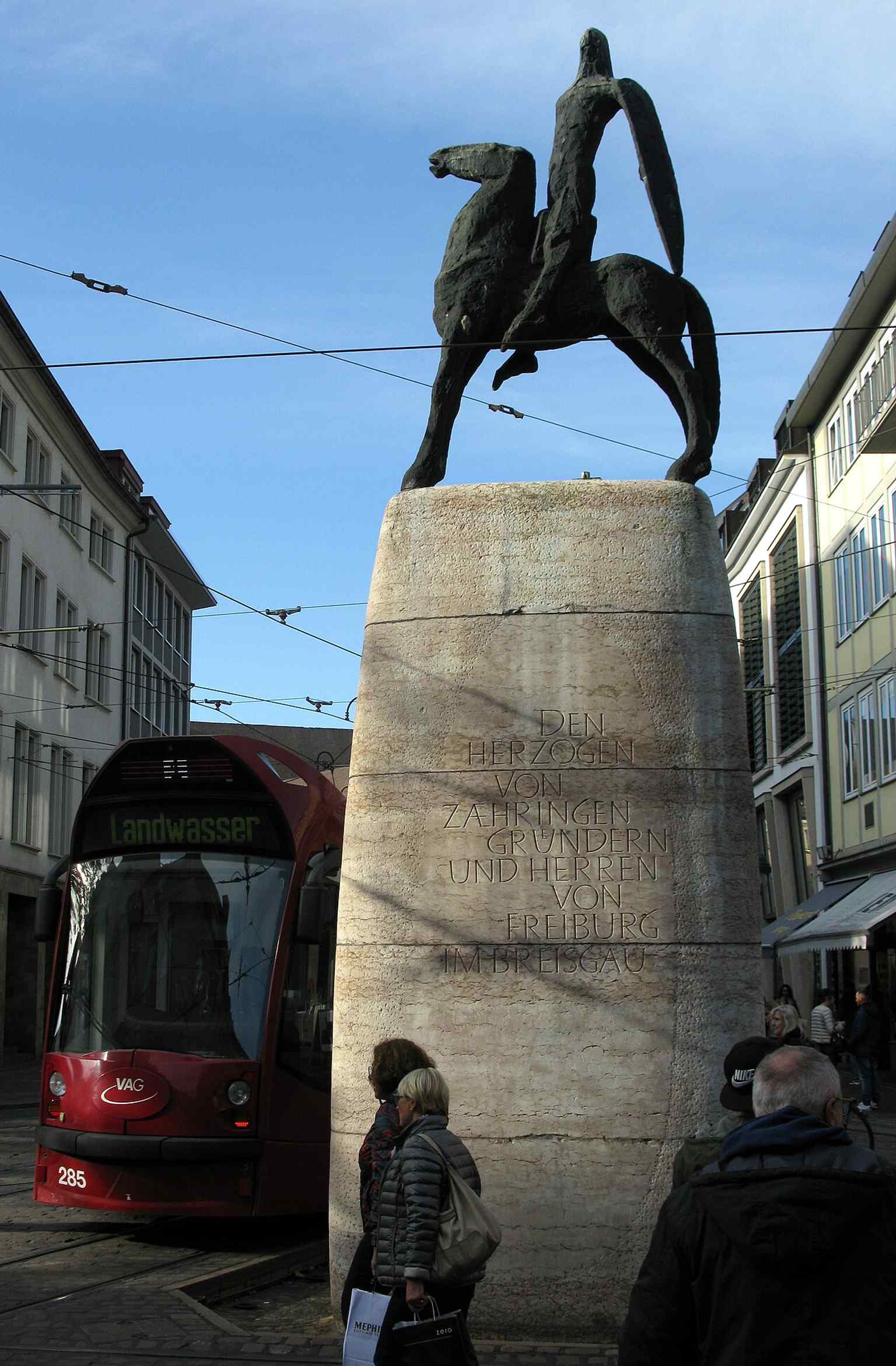 A clear street-level view of the modern Bertoldsbrunnen, showing how the monument stands at the heart of pedestrian traffic.