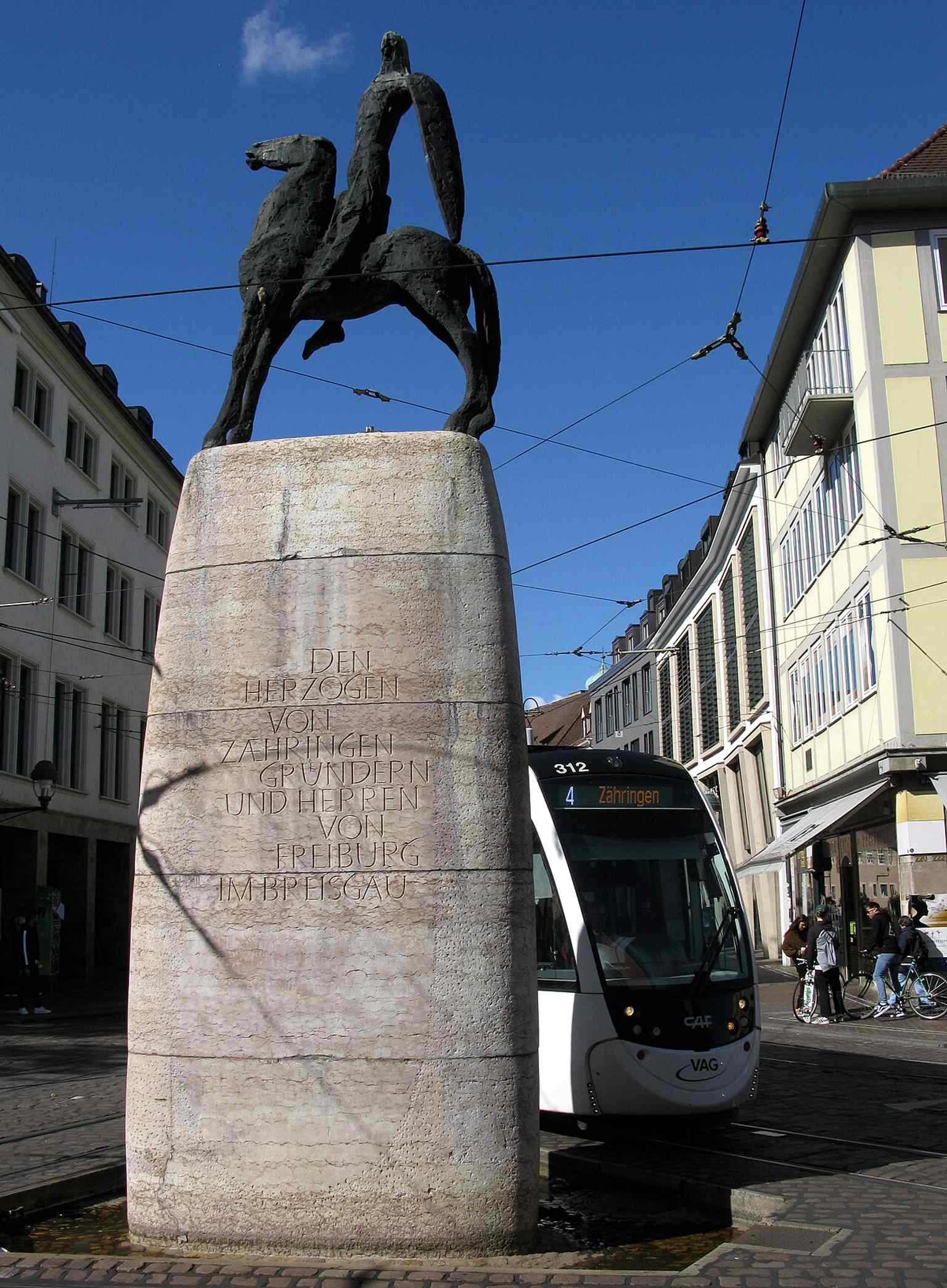 A tram gliding past the Bertoldsbrunnen, a good illustration of the square’s constant mix of public transport and city life.