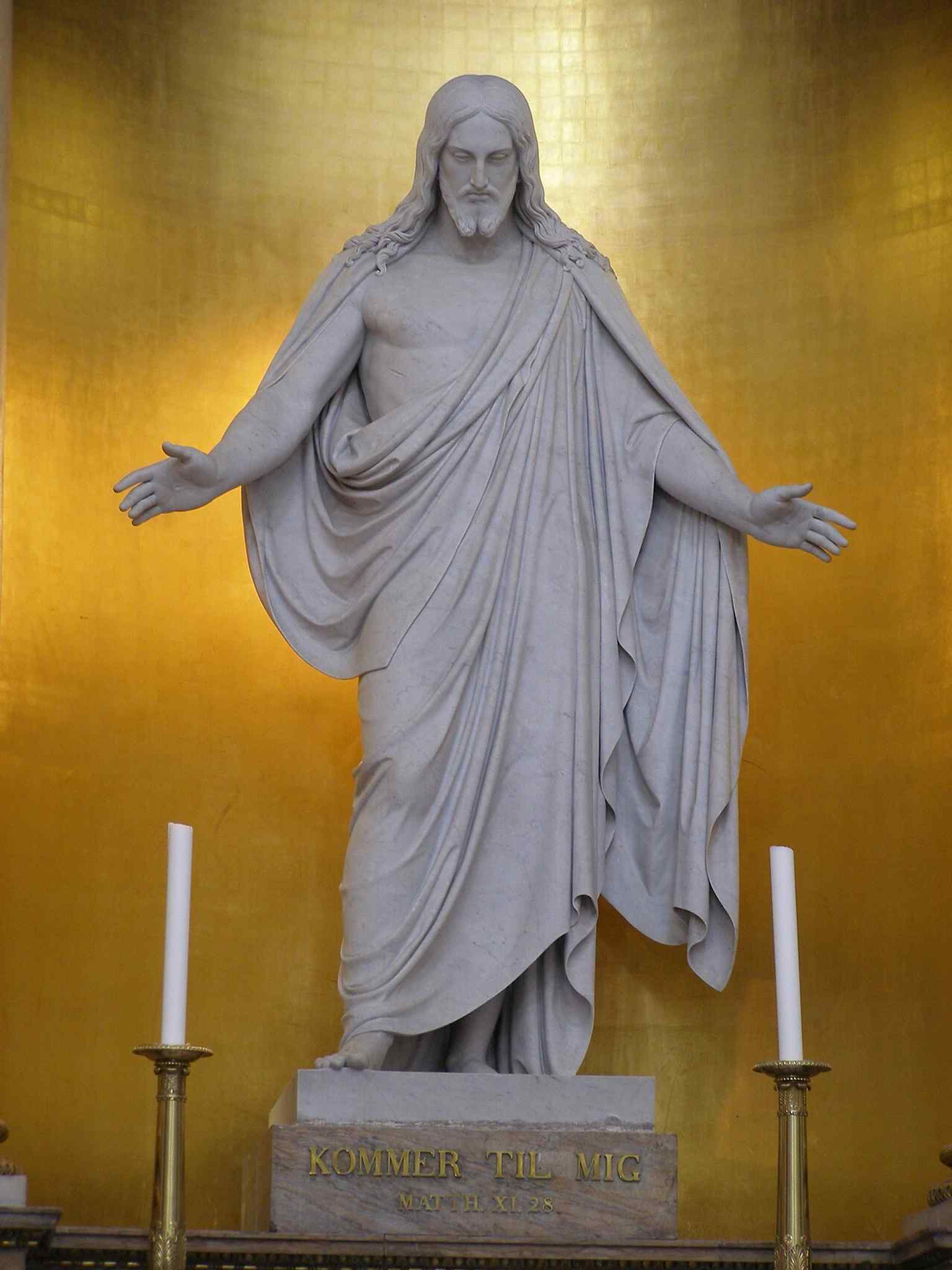 The original 11-foot white Carrara marble statue of Christus by Bertel Thorvaldsen, installed in Copenhagen's Church of Our Lady in 1833 after the church was rebuilt from fire.