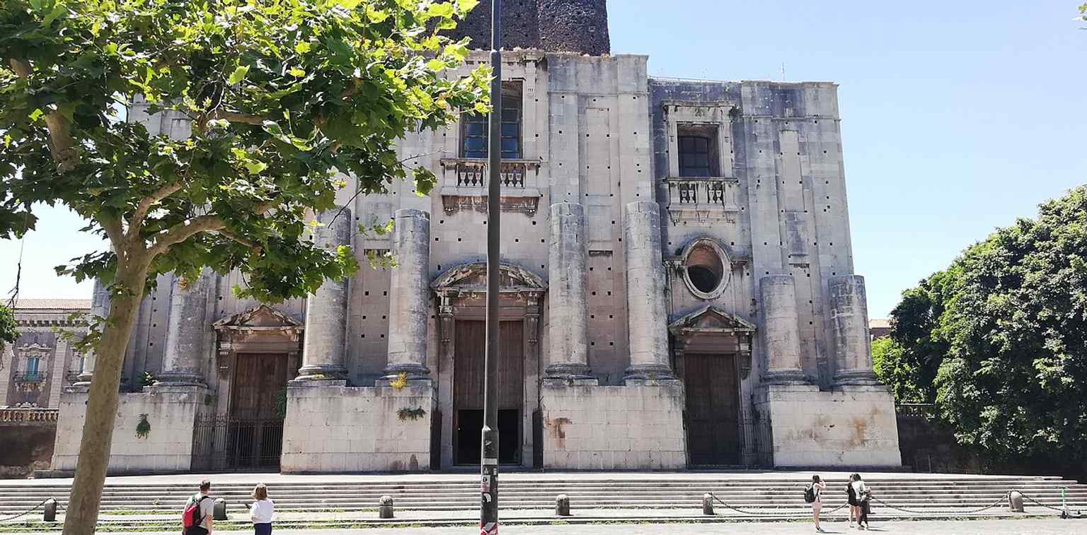 A broad exterior angle that helps show the massive footprint of the building and its urban setting in central Catania.