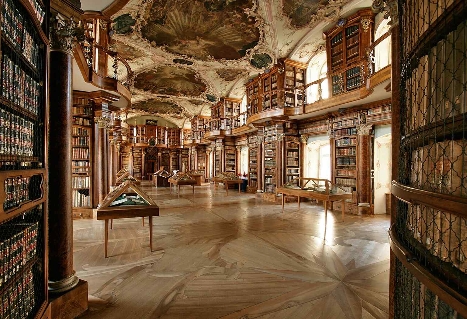 A wide interior view of the baroque hall, helpful for showing the room’s proportions and gallery level.