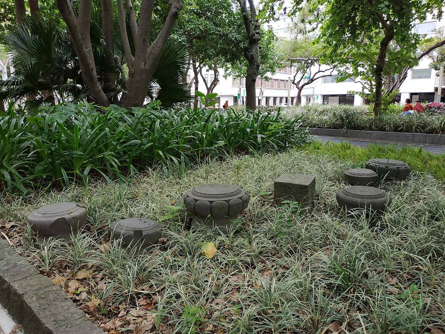 Remains from the former Taipei Tianhou Temple, preserved in the park as scattered relics of an older city landscape.