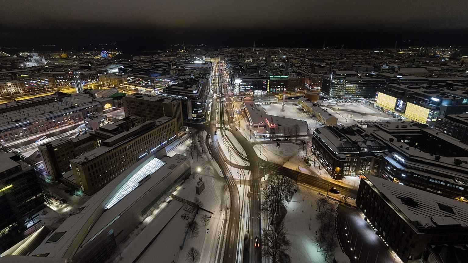 A night aerial view over Mannerheiminaukio, the square where Mannerheim’s equestrian statue stands in front of the city center.