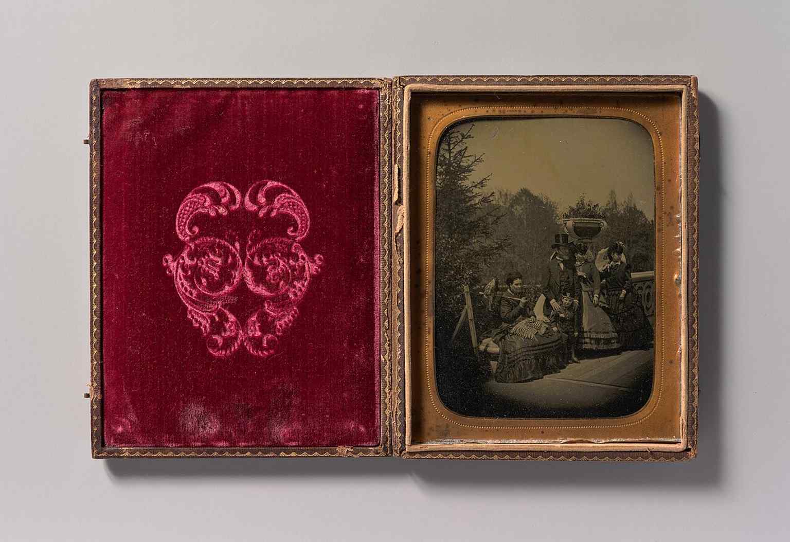 A 1865 tintype view of Bow Bridge with visitors, capturing Central Park as a popular promenade in its early decades.