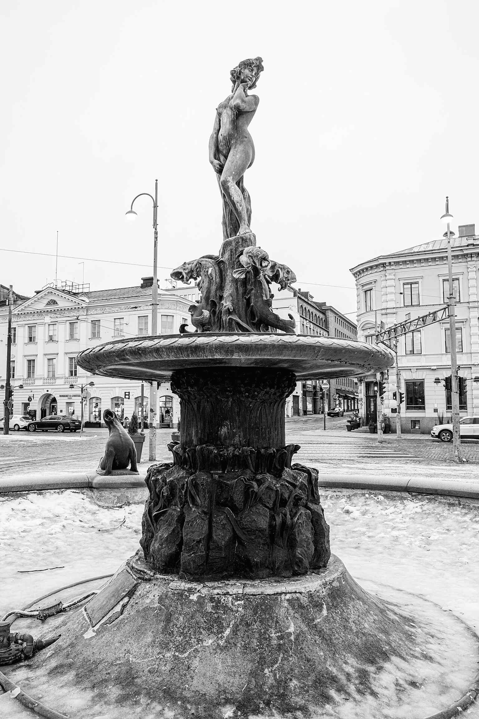 Winter close view of the fountain, showing the bronze figure and basin that were fully restored in 2023–2024.