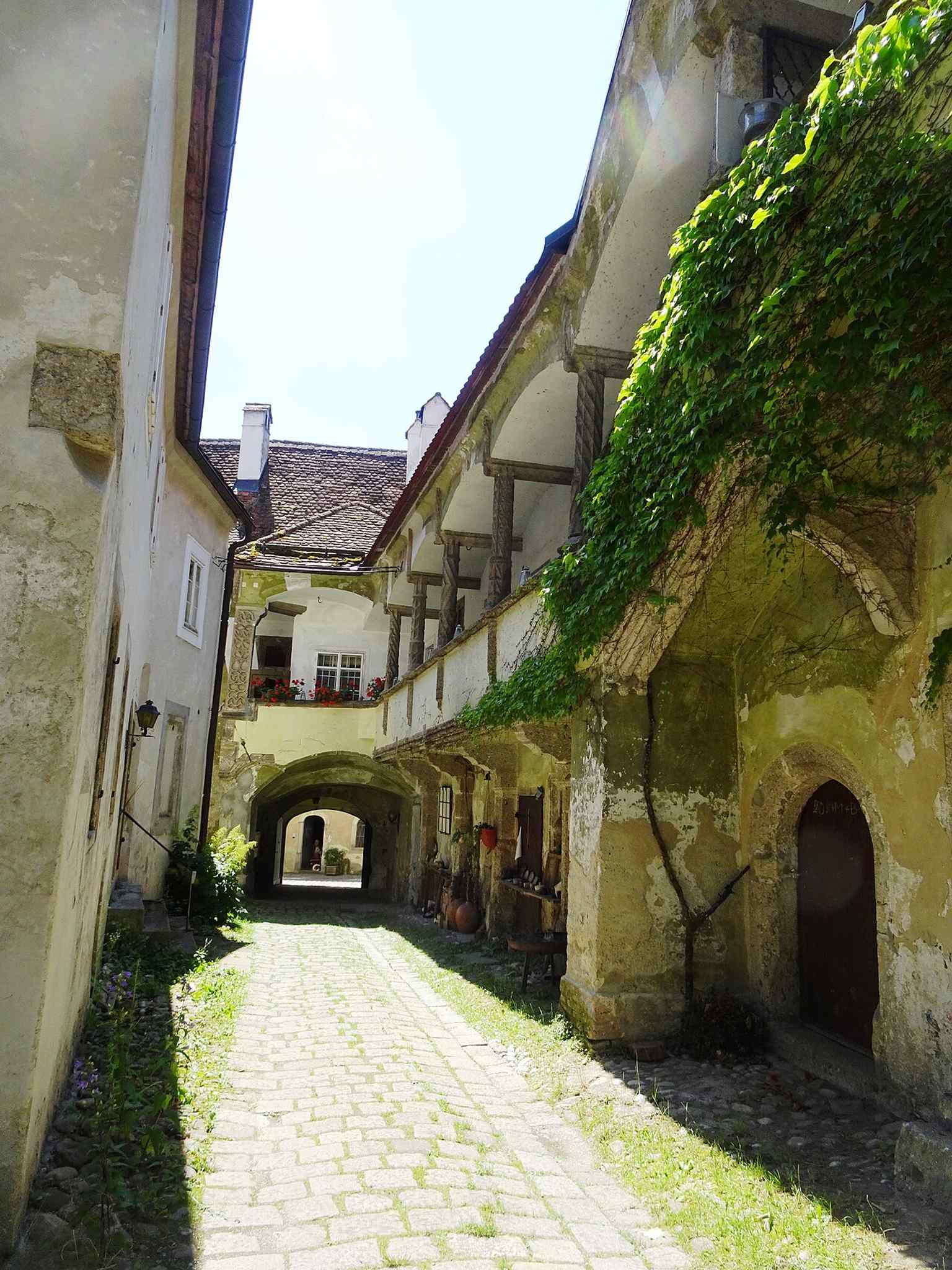 A tight look at the arcaded passage, capturing the decorative structure of the Renaissance courtyard.