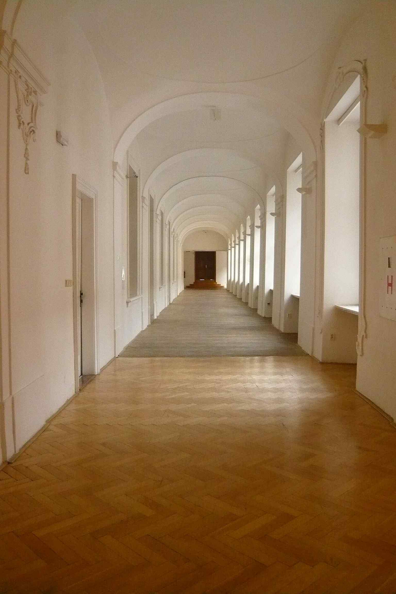 A long corridor inside the old palace, reflecting the later administrative use of the former monastery.
