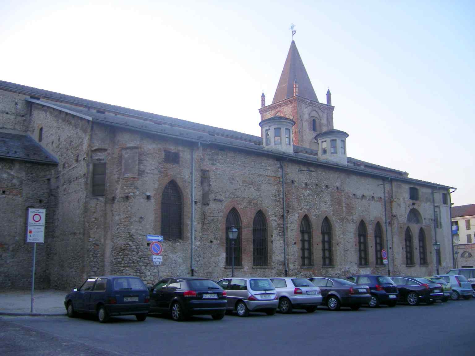 This distant perspective showcases the vastness of the San Francesco Complex, recognized as a national monument and a rare example of medieval architecture in Cuneo.
